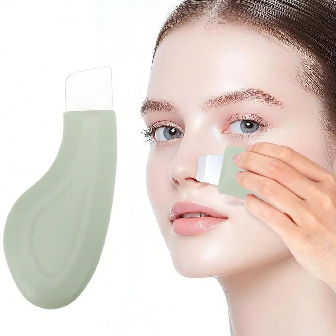 Person applying a green facial mask to their face with a white applicator.